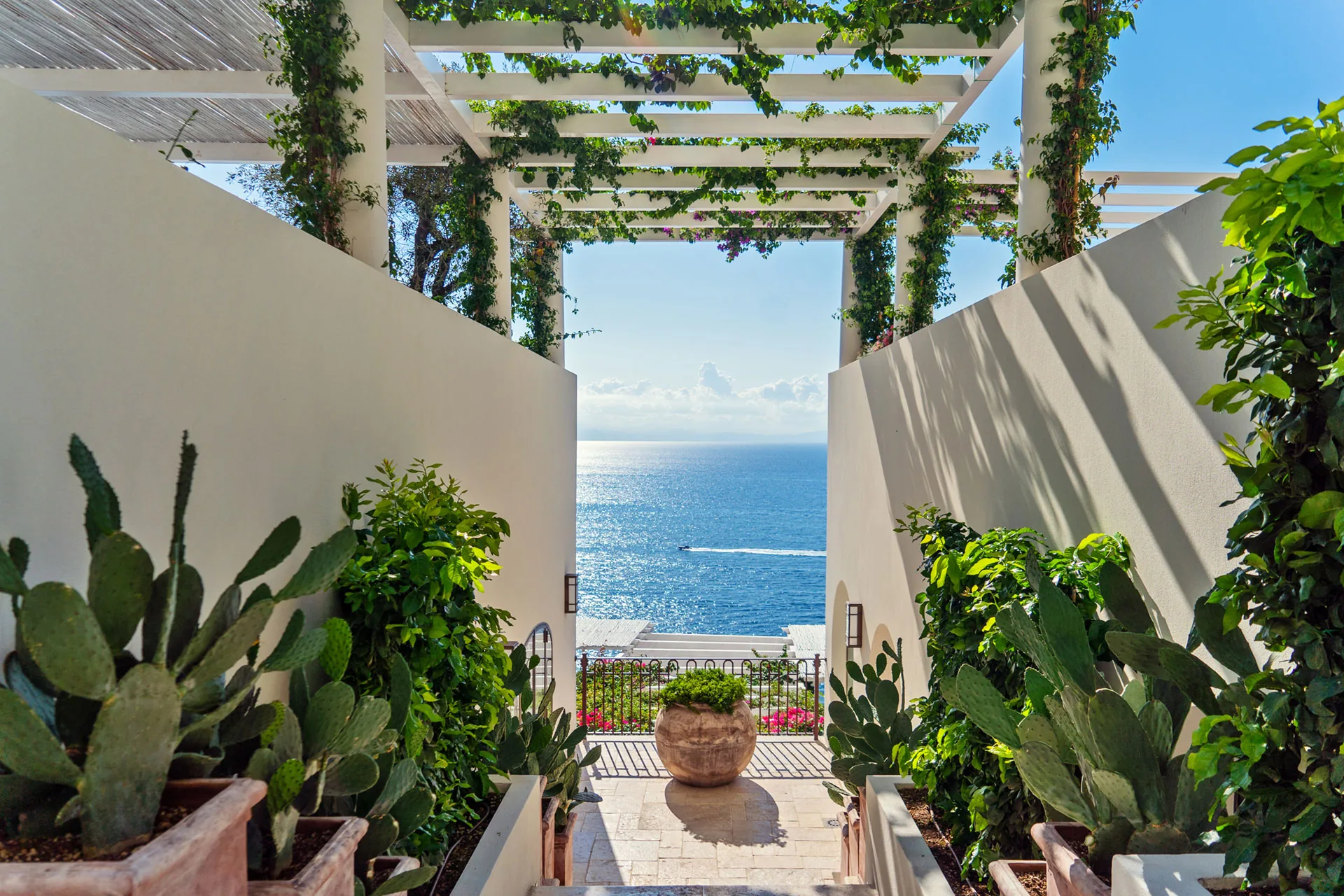 Borgo Santandrea: a white terrace walkway opening to the sea