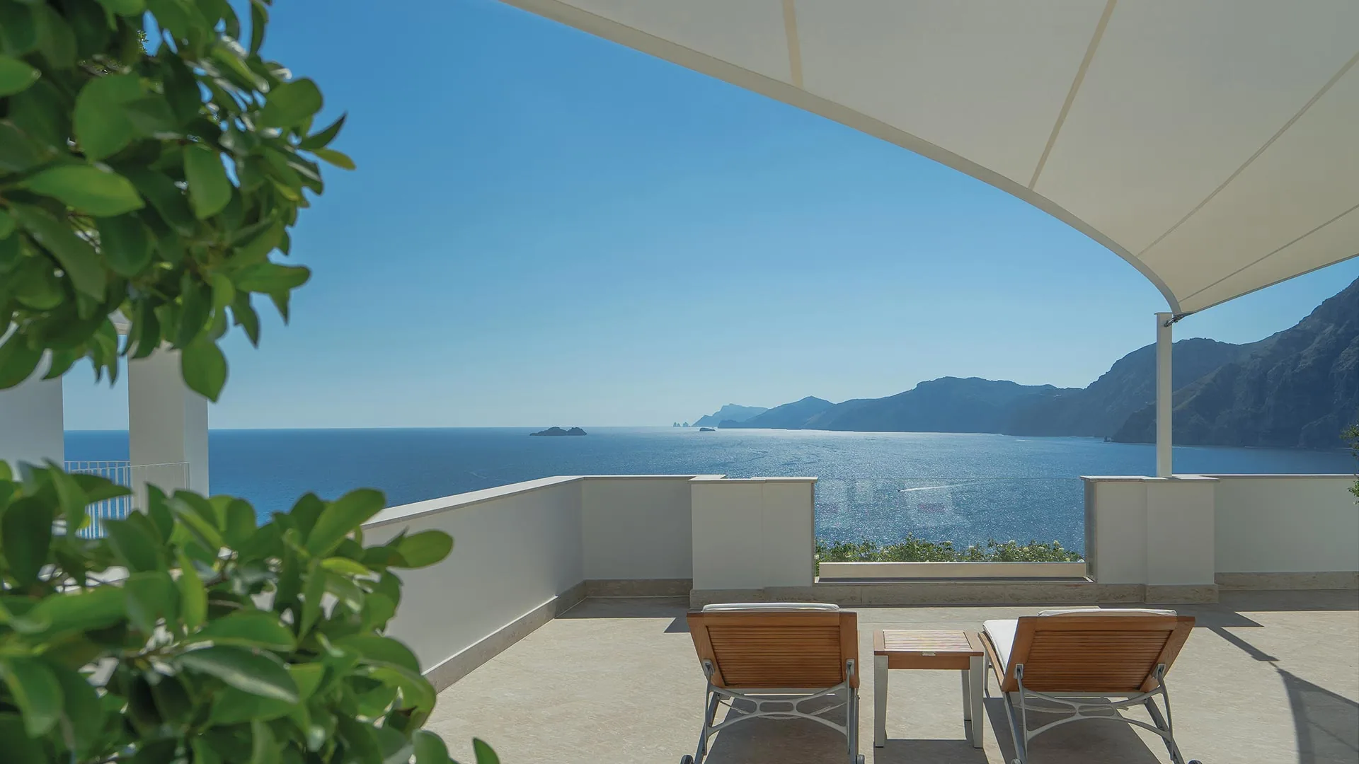 Casa Angelina in Praiano: a white terrace looking along the coast to the sea
