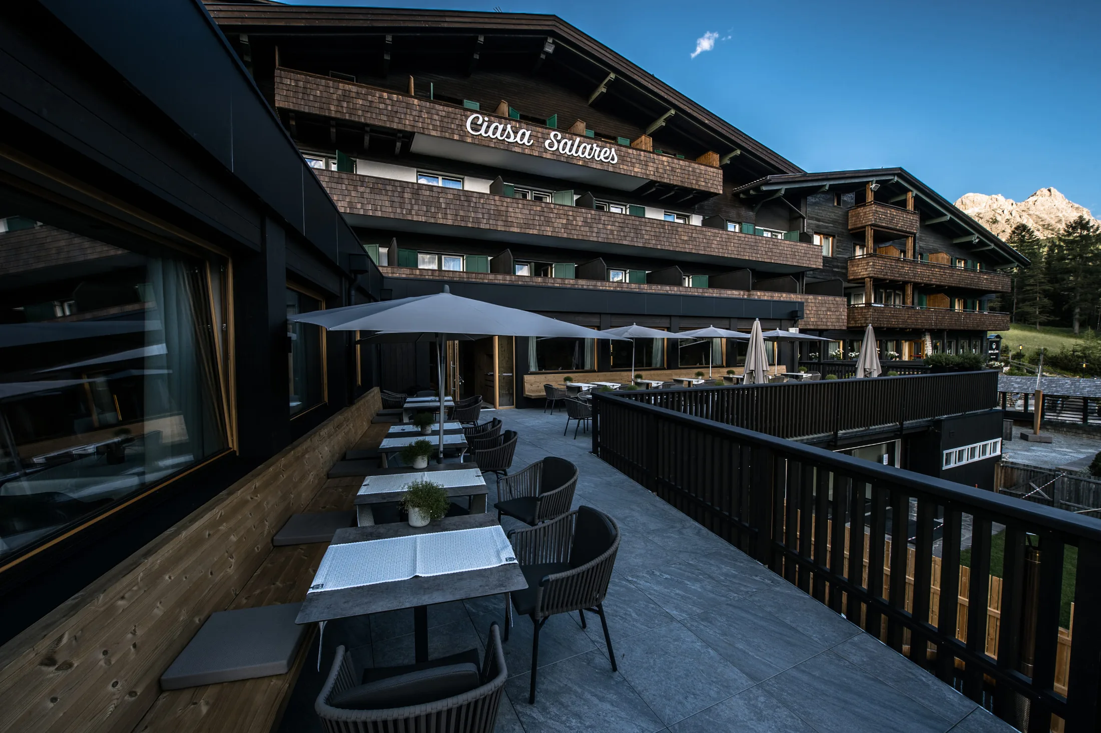 Ciasa Salares at Armentarola, San Cassiano: the hotel terrace and the house with the Ciasa Salares name on the balcony