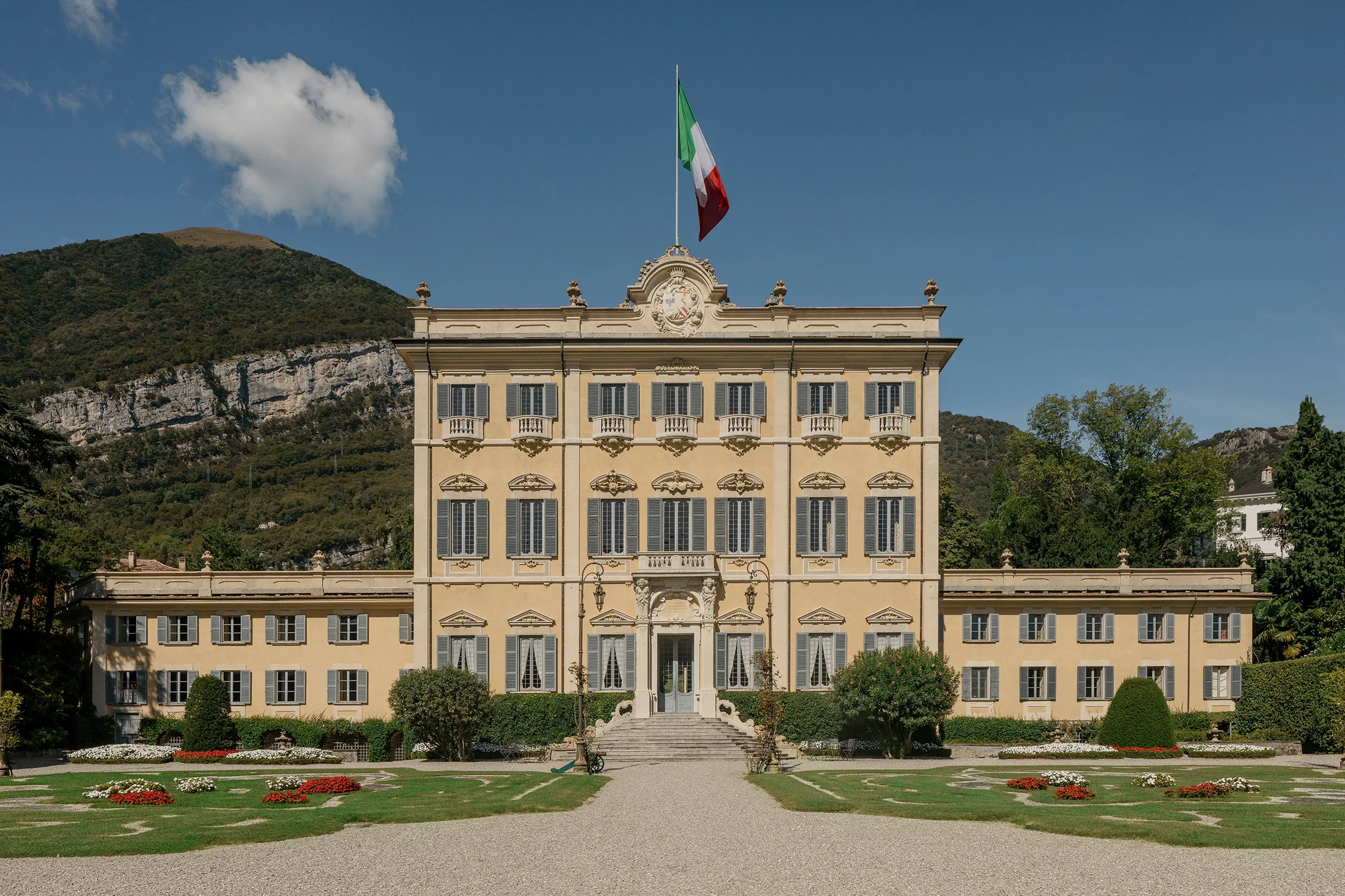 Villa Sola Cabiati in Tremezzo: the Neoclassical villa and formal gardens, with the mountain behind — Grand Hotel Tremezzo