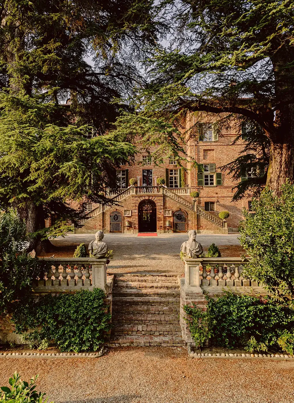 Castello di Casalborgone, the brick castle seen through cedars from the garden.