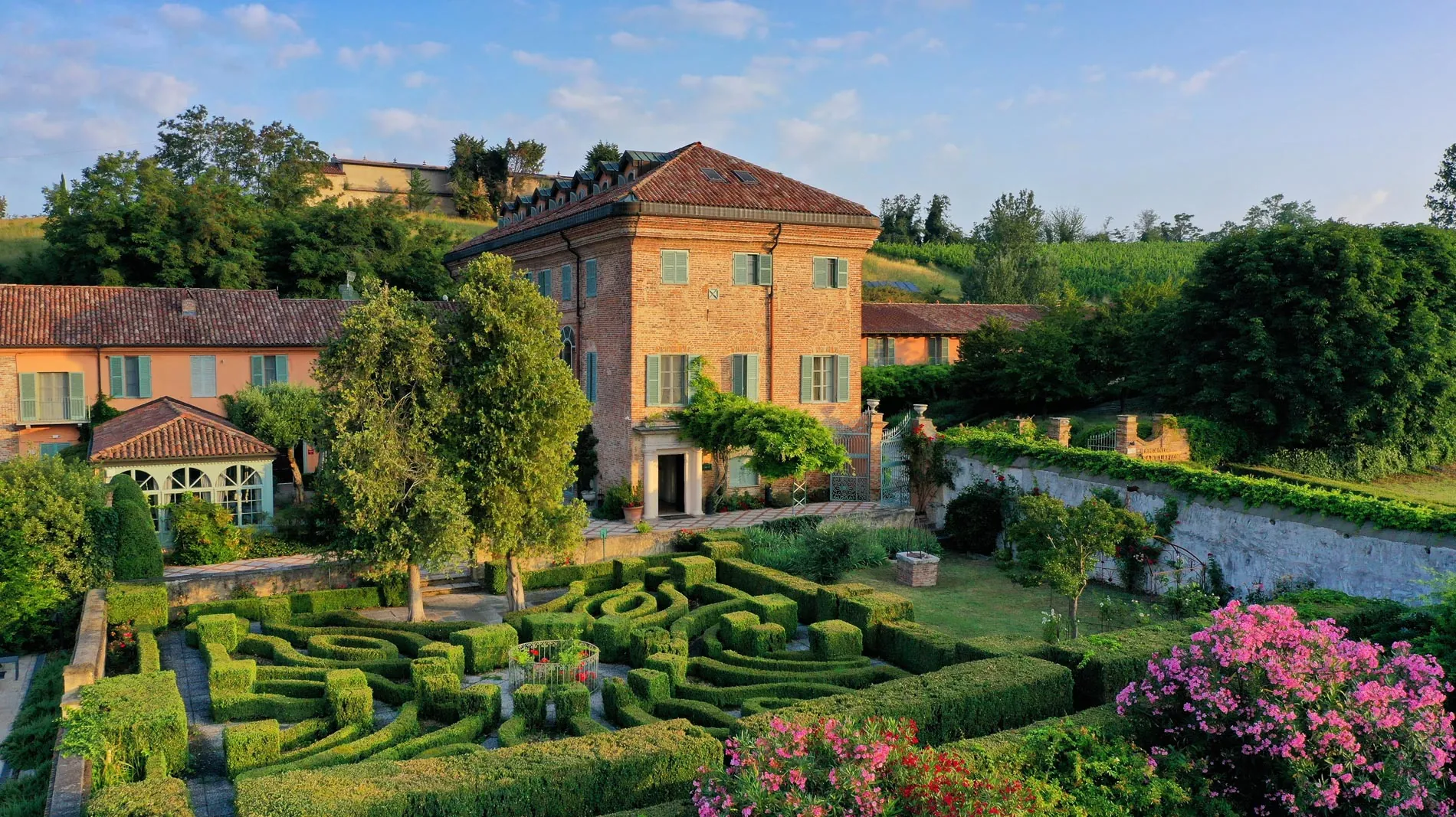 Relais Sant’Uffizio, the brick house and formal garden in the hills of Penango.