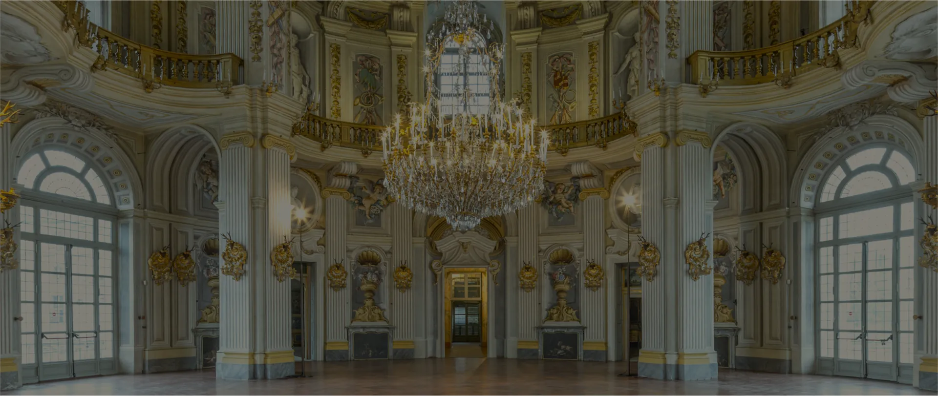 The Central Hall of the Palazzina di Caccia di Stupinigi, a circular baroque room with a chandelier.